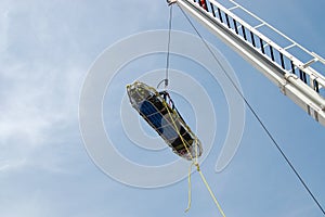 Stokes basket being lowered by aerial ladder