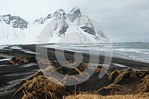 Stokksnes Peninsula, Vestrahorn mountains and black sand dunes over the ocean, Iceland