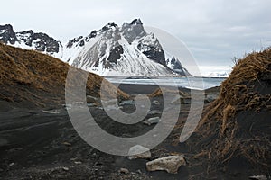 Stokksnes Peninsula, Vestrahorn mountains and black sand dunes over the ocean, winter landscape, Iceland