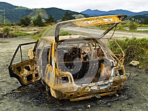 Stolen burnt-out rusty car's back view photo