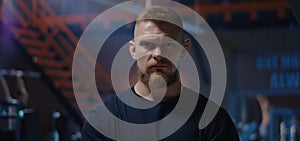 Stolid young man looking at camera