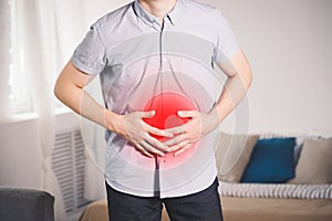 Stomach ache, man with abdominal pain suffering at home
