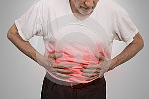 Stomach ache, man placing hands on the abdomen photo