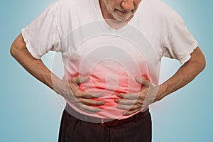 Stomach ache, man placing hands on the abdomen photo