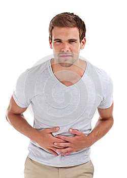 Stomach ache, pain and portrait of man on a white background with indigestion, hurt and injury. Health, sick and photo