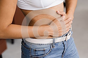 Stomach pain. Sick african american girl hold abdomen because it hurts. Pancreatitis disease of pancreas becomes