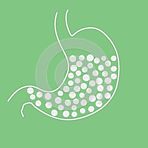 Stomach with pills on green