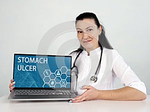STOMACH ULCER Peptic Ulcer text in list. Hematologist looking for something at laptop