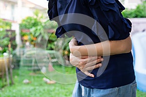 Stomachache painful and unhealty from Asian woman in the garden photo