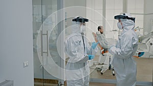 Stomatological doctors wearing ppe suits at dental clinic