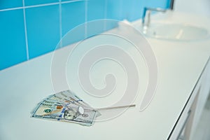 Stomatological oral mirror lies on table with money dentist office