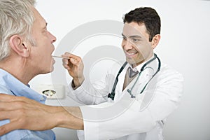 Stomatologist Checking Patient's Throat photo