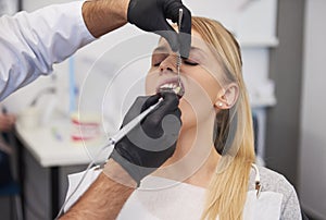 Stomatologist giving woman anesthesia in dentist`s clinic