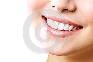 Stomatology concept. Partial portrait of a girl with white teeth smiling. Closeup of young woman at dentist`s, studio