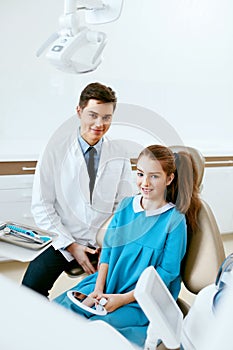 Stomatology. Dentistry Doctor And Patient In Dentist Office