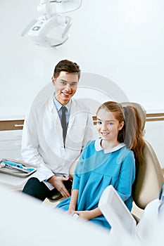 Stomatology. Dentistry Doctor And Patient In Dentist Office