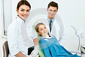 Stomatology. Dentistry Doctors And Patient In Dentist Office