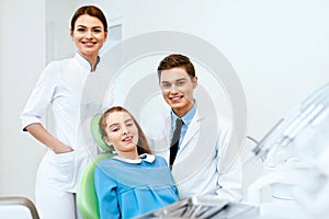 Stomatology. Dentistry Doctors And Patient In Dentist Office