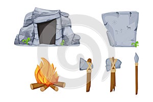 Stone age tools set with cave, fireplace, rock with drawings, axe, hammer and sharp stick isolated on white background in cartoon