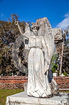 Stone angel headstone on a gravesite.