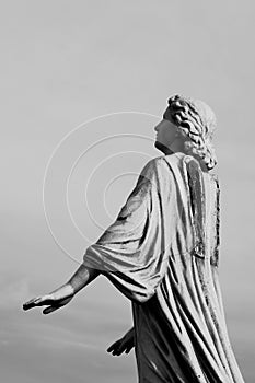 Stone angel statue with missing wings on historic cemetery