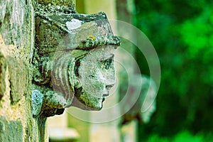 Stone angel woman gargoyle sculpture at church entrance