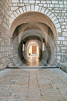 Stone arc passage at Krk Cathedral in old center - Croatia