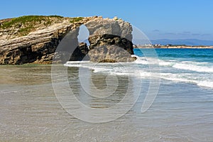 Stone arch on the beach of the cathedrals, famous place in Galicia Spain