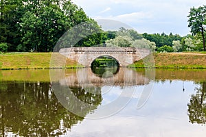 Stone arch bridge across lake in Gatchina  Russia