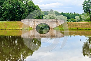 Stone arch bridge across a lake in Gatchina, Russia