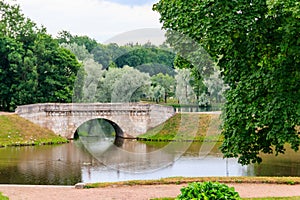 Stone arch bridge across lake in Gatchina, Russia