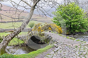Stone arch bridge across a small stream in Lake District National Park