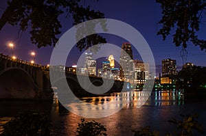 Stone Arch bridge and the downtown Minneapolis Skyline city at night. Long exposure