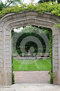 A stone arch entry, covered in a vine, leading to the sunken garden, at Rotary Botanic Gardens in Wisconsin