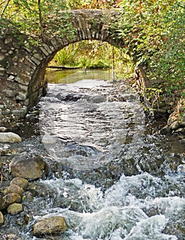 Stone arch over rushing stream