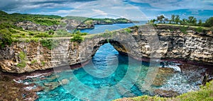 Stone arch over the sea. Broken beach, Nusa Penida , Indonesia. photo