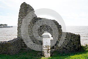 Stone arch ruin at talmont on the cliff overlooking a fishing hut