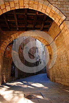 Stone arch to narrow alleyway photo