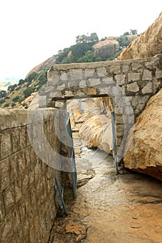 The stone arch of way to jain stone beds at sittanavasal cave temple complex.