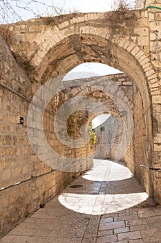 Stone  arched connections on the quiet small St James Street in the Armenian quarter in the old city of Jerusalem, Israel