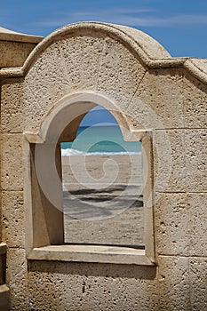 A stone archway on the beach in Ft.Lauderdale with the view of the ocean.