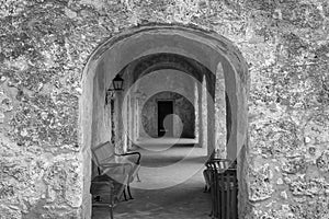 Stone archways leading into walkway in black and white