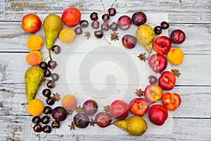 Stone Autumn fruit on the wooden table, flat view.