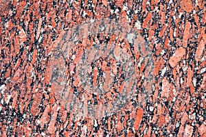 Stone Background of mottled red granite igneous rock