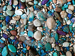 Stone background with round colorful pebbles