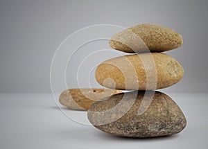 Stone balance on gray background