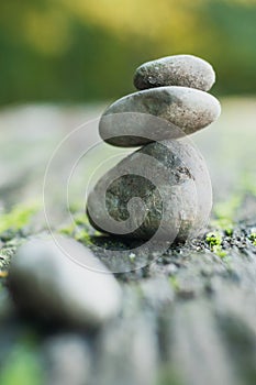 stone balance of pebbles on wooden table in outdoor
