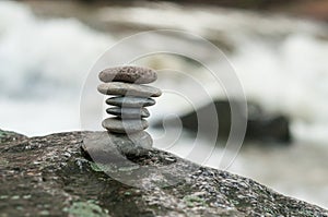 Stone balance on rock in border river