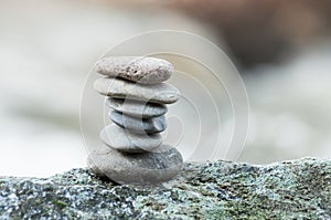 Stone balance on rock in border river