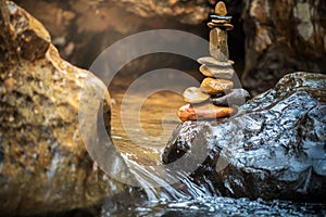 Stone balance stacking at riverside and morning sunlight.